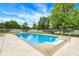 Sparkling in-ground swimming pool with concrete surround and diving board in a fenced backyard at 48 E Wisteria Way, Westfield, IN 46074