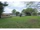 Spacious backyard with lush green grass and mature trees at 489 Highland St, Morgantown, IN 46160