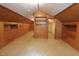 Bright room with wood paneling, built-in drawers, shelving, and a closet at 489 Highland St, Morgantown, IN 46160