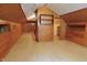 Spacious room with wood paneling, built-in drawers, shelving, and closet at 489 Highland St, Morgantown, IN 46160