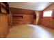 Charming bedroom with hardwood paneling, built-in drawers and window with curtains at 489 Highland St, Morgantown, IN 46160