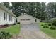 Detached garage with wide driveway, providing ample parking and storage space at 489 Highland St, Morgantown, IN 46160