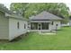Home's exterior with a well-maintained lawn and detached garage at 489 Highland St, Morgantown, IN 46160
