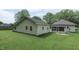 Home's exterior with a well-maintained lawn and detached garage at 489 Highland St, Morgantown, IN 46160