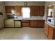 Kitchen featuring linoleum flooring, wood cabinets and standard appliances at 489 Highland St, Morgantown, IN 46160