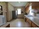 View of the kitchen featuring wood cabinets, white countertops, linoleum flooring, and appliances at 489 Highland St, Morgantown, IN 46160