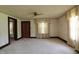 Bright, open living room with neutral carpet and natural light from the windows at 489 Highland St, Morgantown, IN 46160