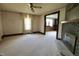 Bright living room with fireplace, ceiling fan, and large windows for natural light at 489 Highland St, Morgantown, IN 46160
