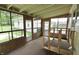 Enclosed sunroom with large windows and wood paneling at 489 Highland St, Morgantown, IN 46160