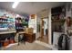 Versatile basement area with neutral carpet, convenient storage shelves, and easy access to other areas at 5041 Norcroft Dr, Indianapolis, IN 46221