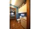 Hall bathroom with white cabinets, toilet, and laminate floors at 5041 Norcroft Dr, Indianapolis, IN 46221