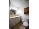Bathroom with an undermount sink, oak cabinets, and a neutral-toned tile floor at 5041 Norcroft Dr, Indianapolis, IN 46221