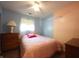 Well-lit bedroom with light colored walls, a ceiling fan, and hardwood-style floors at 5041 Norcroft Dr, Indianapolis, IN 46221