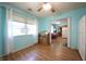 Dining area with laminate flooring, a large window, and access to the kitchen at 5041 Norcroft Dr, Indianapolis, IN 46221