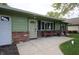 Close up shot of the brick-lined front porch with chairs at this ranch-style home at 5041 Norcroft Dr, Indianapolis, IN 46221