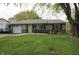 Charming ranch-style home with an inviting green lawn and brick accents at 5041 Norcroft Dr, Indianapolis, IN 46221