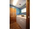 Bright laundry area features a washer, dryer, and storage space at 5041 Norcroft Dr, Indianapolis, IN 46221