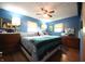 Comfortable main bedroom with blue walls, ceiling fan, and natural light from two windows at 5041 Norcroft Dr, Indianapolis, IN 46221