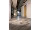 Basement hallway shows vinyl floors, exposed ductwork and plumbing, and white walls at 518 Cherry St, Beech Grove, IN 46107