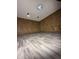 Unfinished basement area features wood paneled walls and updated gray wood-look vinyl floors at 518 Cherry St, Beech Grove, IN 46107