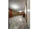 Finished basement with stylish gray flooring, wood-paneled walls, and built-in shelving at 518 Cherry St, Beech Grove, IN 46107