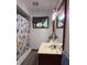 Bathroom with a single sink vanity, and a shower with a colorful curtain at 518 Cherry St, Beech Grove, IN 46107