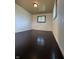 Empty bedroom with dark wood floors, white walls, and a single window at 518 Cherry St, Beech Grove, IN 46107