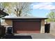 Spacious detached two car garage with brick facade and a brown garage door at 518 Cherry St, Beech Grove, IN 46107