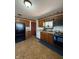 Traditional kitchen with wood cabinets, a black refrigerator, and standard appliances at 518 Cherry St, Beech Grove, IN 46107