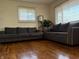 Spacious living room features hardwood floors, two gray sofas, and natural lighting at 518 Cherry St, Beech Grove, IN 46107