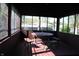 Enclosed porch featuring a wood picnic table and bench set with views to the backyard at 518 Cherry St, Beech Grove, IN 46107