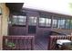 Enclosed porch featuring screens, wood floor, a metal door, and access to the back yard at 518 Cherry St, Beech Grove, IN 46107