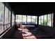 Enclosed porch featuring a wood picnic table and bench set with views to the backyard at 518 Cherry St, Beech Grove, IN 46107