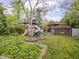Backyard featuring a fire pit, garden, and a playground set at 5181 E Pleasant Run Pkwy S Dr, Indianapolis, IN 46219