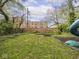 Backyard features a wooden fence, fire pit, and a partially visible playground set at 5181 E Pleasant Run Pkwy S Dr, Indianapolis, IN 46219