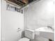 Small bathroom featuring a simple sink, toilet, and tiled walls, with a vintage feel and basic fixtures at 5181 E Pleasant Run Pkwy S Dr, Indianapolis, IN 46219