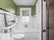 Charming bathroom with tiled walls, a classic tub, and a bright window at 5181 E Pleasant Run Pkwy S Dr, Indianapolis, IN 46219