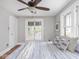 Bright bedroom features a ceiling fan, white-trimmed windows, and a comfortable bed with striped bedding at 5181 E Pleasant Run Pkwy S Dr, Indianapolis, IN 46219