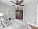 Bedroom with ceiling fan, striped bedding and decor at 5181 E Pleasant Run Pkwy S Dr, Indianapolis, IN 46219