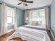 Cozy bedroom with hardwood floors, natural light, and comfortable furnishings at 5181 E Pleasant Run Pkwy S Dr, Indianapolis, IN 46219