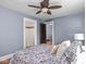 Bedroom with a ceiling fan, closet, hardwood floors, and a window for natural light at 5181 E Pleasant Run Pkwy S Dr, Indianapolis, IN 46219