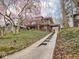 Two-story brick home with a concrete driveway and steps through the landscaped front yard at 5181 E Pleasant Run Pkwy S Dr, Indianapolis, IN 46219
