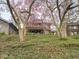 Two-story brick home surrounded by mature trees and lush landscaping at 5181 E Pleasant Run Pkwy S Dr, Indianapolis, IN 46219