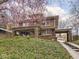 Two-story brick home with a covered parking area and lush front lawn at 5181 E Pleasant Run Pkwy S Dr, Indianapolis, IN 46219