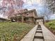 Two-story brick home with a covered parking area and landscaped front yard at 5181 E Pleasant Run Pkwy S Dr, Indianapolis, IN 46219