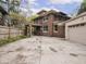 A two-story brick home with a balcony and a detached two-car garage at 5181 E Pleasant Run Pkwy S Dr, Indianapolis, IN 46219