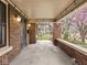 Covered front porch with brick columns and ample space for outdoor seating at 5181 E Pleasant Run Pkwy S Dr, Indianapolis, IN 46219