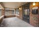 Charming brick porch with vintage lighting and a historic Irvington welcome sign at 5181 E Pleasant Run Pkwy S Dr, Indianapolis, IN 46219