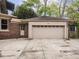 Detached two-car garage with a beige exterior and a concrete driveway at 5181 E Pleasant Run Pkwy S Dr, Indianapolis, IN 46219