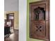 Hallway featuring a vintage telephone nook and view into the living room at 5181 E Pleasant Run Pkwy S Dr, Indianapolis, IN 46219